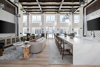 A modern open plan living and kitchen area with a long white marble island.